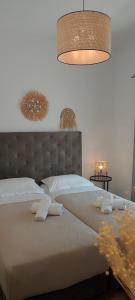 a bedroom with a large bed with two pillows at Maria Studios in Parikia