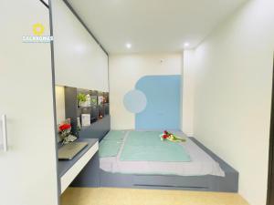 a small bedroom with a bed and a mirror at Dapano Maison in Hanoi