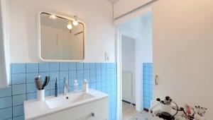 a bathroom with a sink and a mirror at La chambre clé de la forêt in Métairies-Saint-Quirin
