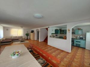 a living room with a couch and a table at Casa din Padure Valea Doftanei in Trăisteni