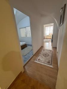 a hallway with a mirror and a room at Apartament central zone in Sibiu