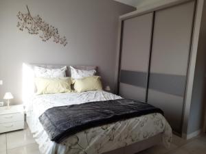 a bedroom with a bed with a black blanket on it at Maison en Provence in Jouques