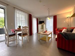 a living room with a couch and a table at Aquamarin Ostseetraumsuite 01 in Neuhaus