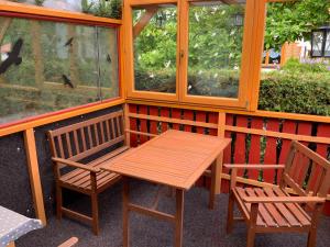 a wooden table and two chairs on a porch at Ferienhaus "Gluch" in Rechlin