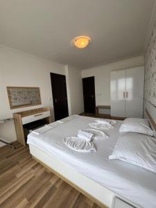 A bed or beds in a room at OLYMP Apart-Complex