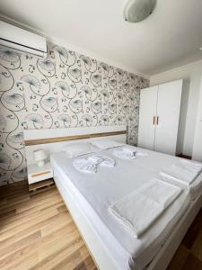 A bed or beds in a room at OLYMP Apart-Complex