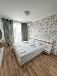 A bed or beds in a room at OLYMP Apart-Complex