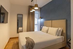 Postel nebo postele na pokoji v ubytování Essence Collection Hotel