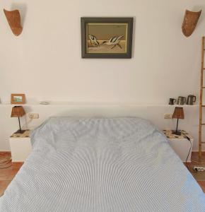 a bedroom with a bed and a picture on the wall at Pita 4, Studio apartment in a Cortijo in Níjar