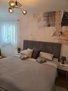 a bedroom with a large bed with pillows on it at Apartmani Andiks Dramalj in Dramalj