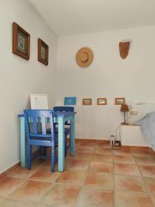 a blue table and a blue chair in a room at Pita 4, Studio apartment in a Cortijo in Níjar