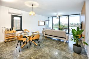 a living room with a table and chairs and a couch at Villa Guadiana Golf 2 in Ayamonte