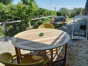 a wooden table and chairs on a patio at B&B La Taerra in Porto San Paolo