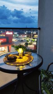a table on a balcony with a view of a city at Apartman Kamelia in Jagodina +18 photos
