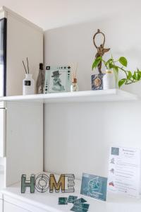 a white shelf with items on top of it at I Due Gelsi Appartamento Blu Cobalto in Monte San Giusto