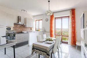 a kitchen and dining room with a table and chairs at I Due Gelsi Appartamento Blu Cobalto in Monte San Giusto +28 photos
