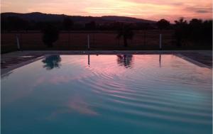 a pool of water with a sunset in the background at Agriturismo La Tana Del Lupo in Cantalupo +9 photos
