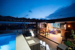 a rooftop patio with a swimming pool at night at Luxury Rooms LaVie - Superior Rooms in Zadar