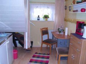a kitchen with a table and a table and chairs at Ferienwohnung Holst in Güstrow