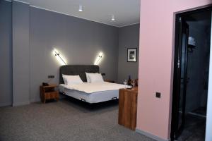 a bedroom with a white bed with two pillows at Hotel Chiatureli in Chiatʼura +29 photos