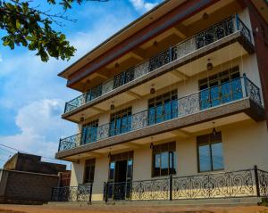 a building with balconies on the side of it at Kanye Bridge Hotel Jinja in Jinja