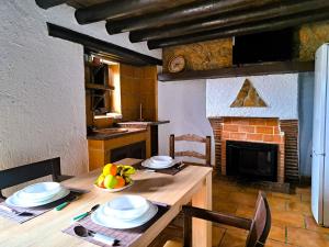 a table with a bowl of fruit on it in a kitchen at Suitur Cortijo de Don Lolo in La Carrera de la Viña