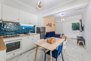 a kitchen and living room with a table and chairs at Adorable Modern Guesthouse in Perea