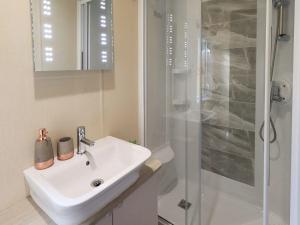 a bathroom with a sink and a shower at Glenridding Lodge in Windermere