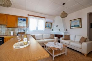 a living room with a couch and a table at Casa d' Acqua in Archangelos