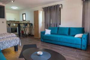 a living room with a blue couch and a table at BRICK Studio in Bajina Bašta