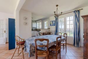 a kitchen and dining room with a table and chairs at Villa du Mene - 60m plage & mer - Wifi in Mesquer +11 photos
