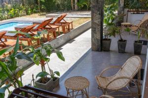 a patio with chairs and a table and a pool at Ethera Arugam bay in Arugam Bay +46 photos