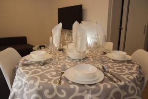a table with plates and wine glasses on it at Triana Fabie in Seville
