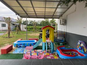 a childrens play area with a slide and a playground at เชียงรายฟิวชั่น in Ban Pa Faek