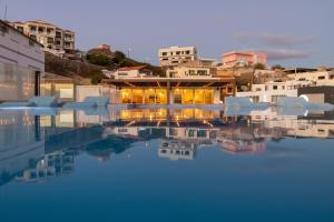 a pool of water with buildings in the background at Ouril Mindelo in Mindelo