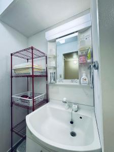 a bathroom with a white sink and a mirror at Ikebukuro-hostel池袋中川301&501 in Tokyo +44 photos