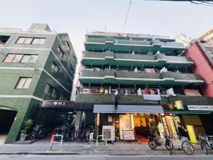 a building with balconies on the side of a street at Ikebukuro-hostel池袋中川301&501-TS0038 in Tokyo