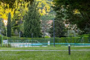 a park with a swimming pool and trees and trees at Beachfront Apartment Mare Strunjan in Strunjan