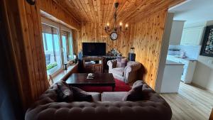 a living room with a couch and a table at Pod Świerkami in Boszkowo
