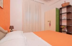 a bedroom with a white bed and a green cabinet at Villa Vega - Makarska by Villas Guide 