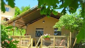 a house with awning on the front of it at Lodge Holidays - Casa Tartufo in Radicosa