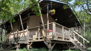 a tree house in a forest with a porch at Lodge Holidays - Casa Tartufo in Radicosa