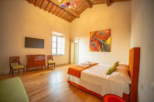 a bedroom with a bed and a tv in a room at Villa Tonelli Boutique B&B in Livorno