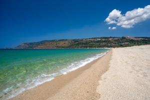 a sandy beach with the ocean and mountains in the background at Casa Tulipano in Plaesano
