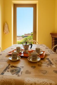 a table with three cups and saucers on it at Casa Tulipano 