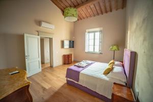 a bedroom with a large bed in a room at Villa Tonelli Boutique B&B in Livorno +29 photos