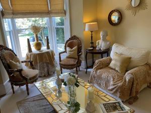 a living room with a couch and chairs and a table at Victorian Retreat - A Serene Sanctuary in Broadstairs
