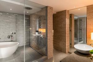 a bathroom with a tub and a shower and a sink at Hyatt Regency Tokyo in Tokyo