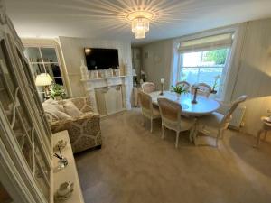 a living room with a table and a couch at Victorian Retreat - A Serene Sanctuary in Broadstairs