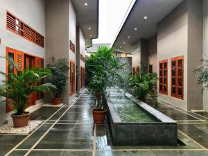 a hallway with potted plants in a building at The Tanjung Bidadari Seminyak in Seminyak